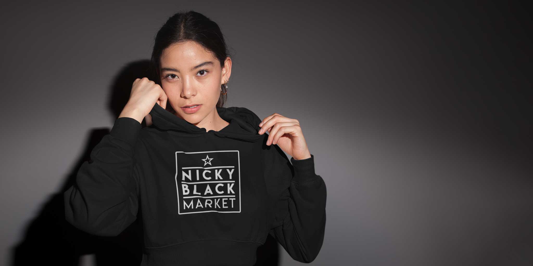 A young woman wearing a Nicky Blackmraket cropped hoodie